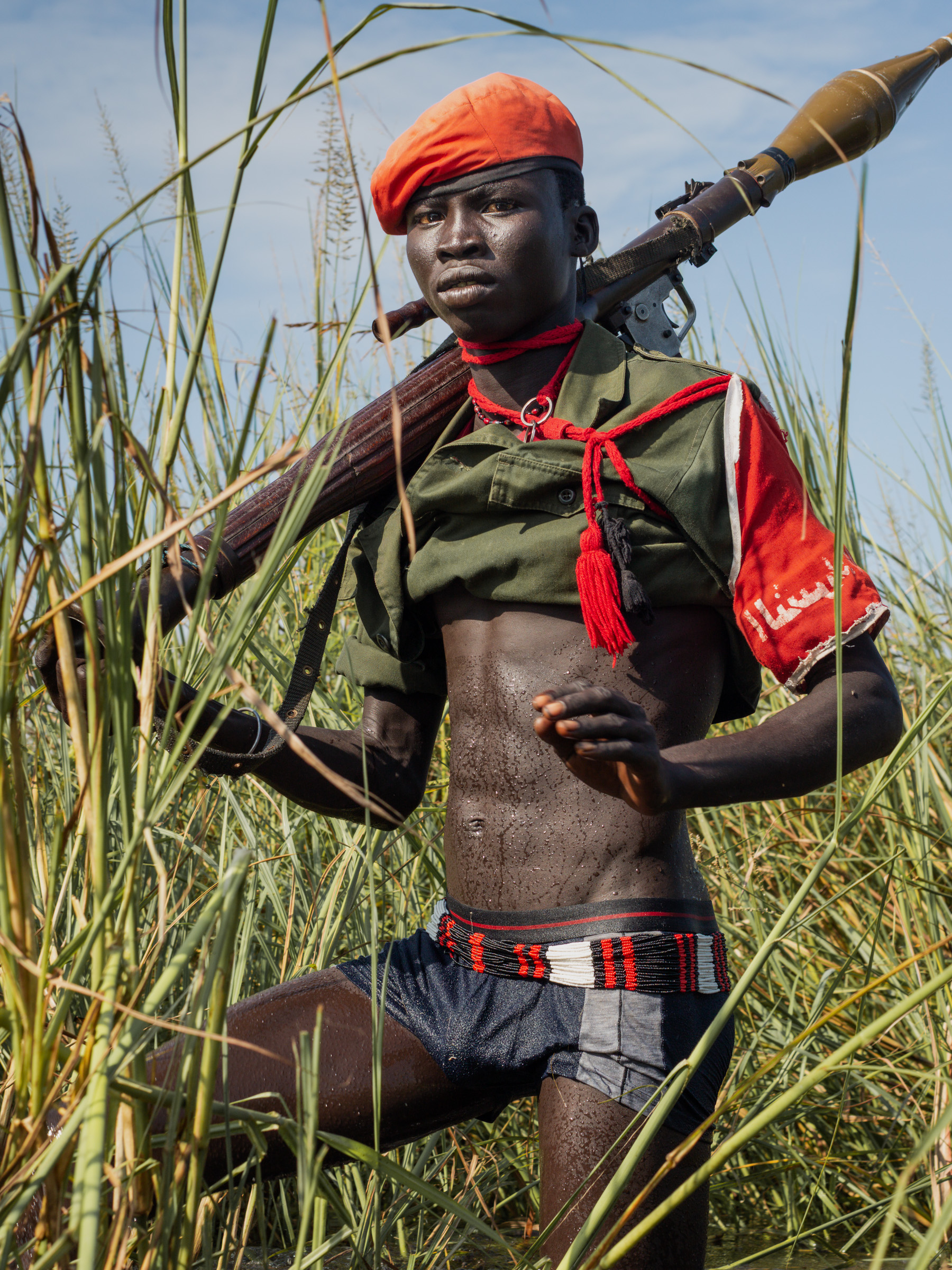 Young Dinka cattle raider with rocket-propelled grenade, Jonglei State, South Sudan — photojournalism by Matthew Abbott