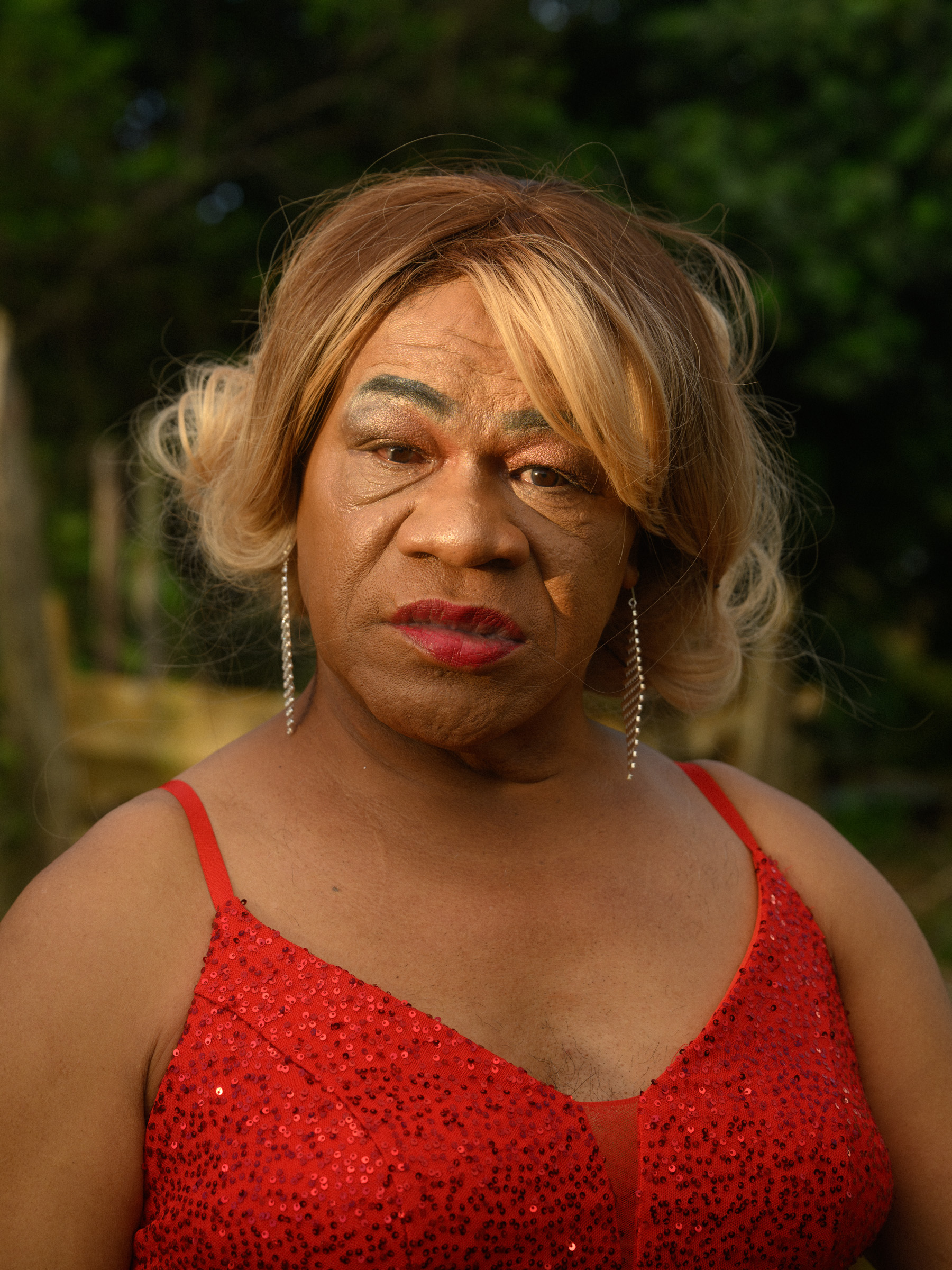 Portrait of a Leiti in a red sequin dress, Kingdom of Tonga — documentary photography by Matthew Abbott